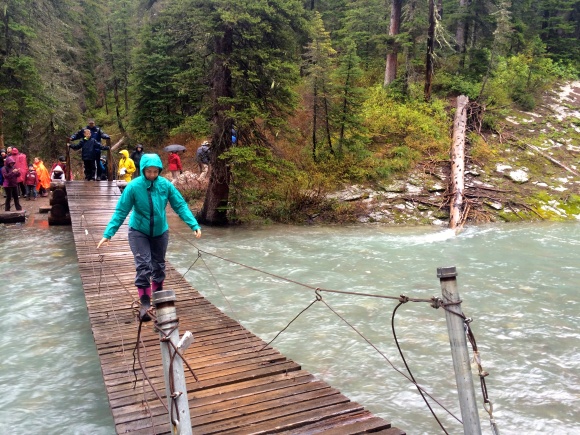 Crossing a suspension bridge below Grinnel Lake